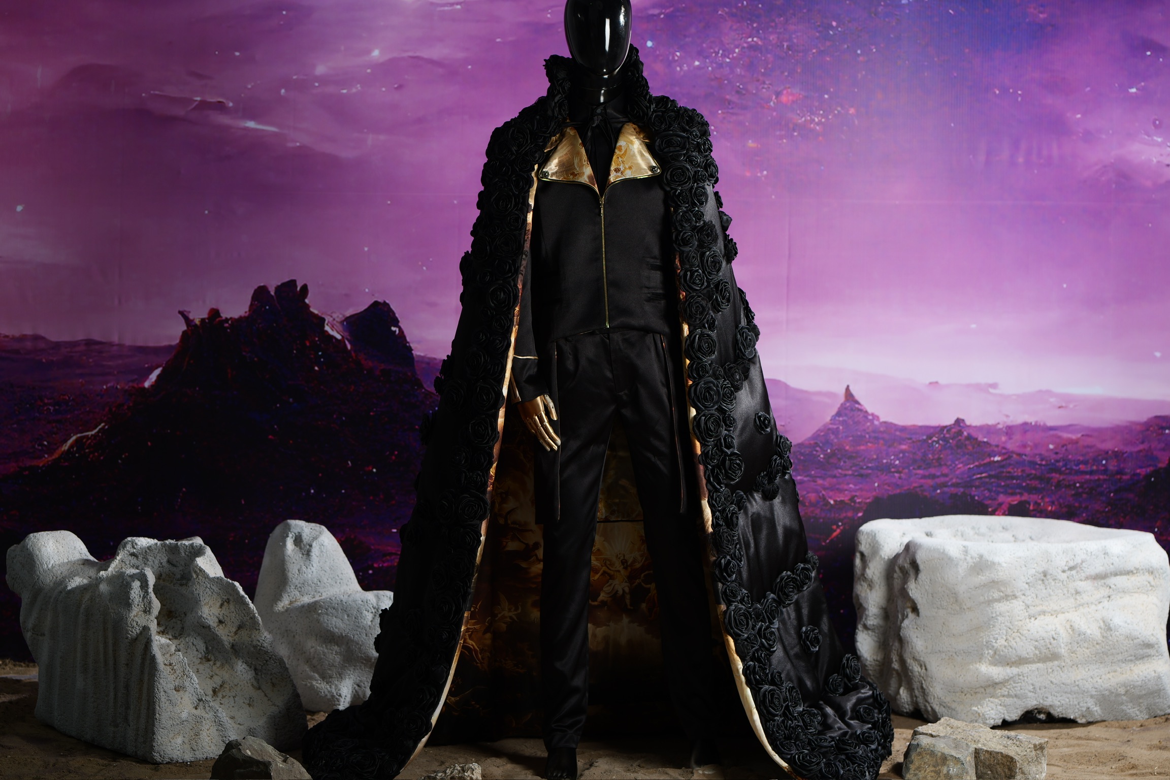 NOCTURNE: Floor-length black satin cape with dimensional rosette applique